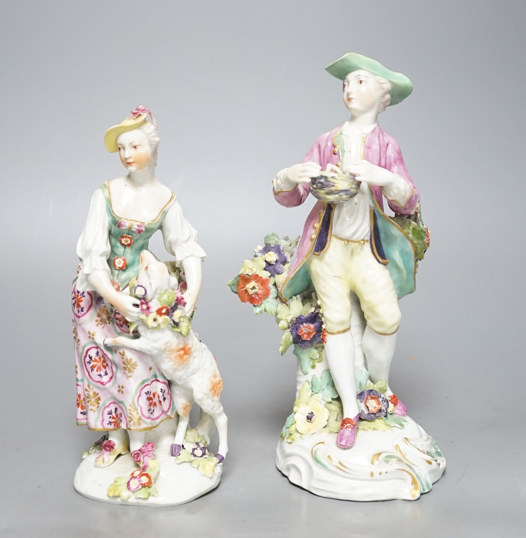 Two Derby porcelain figures of a gentleman holding a bird’s nest and a lady with a sheep, c.1760, 21.5 cms high.